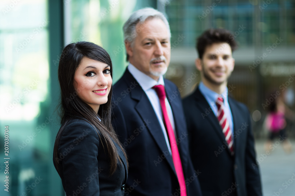 Business team smiling outdoor in a modern urban setting Business team smiling outdoor in a modern urban setting