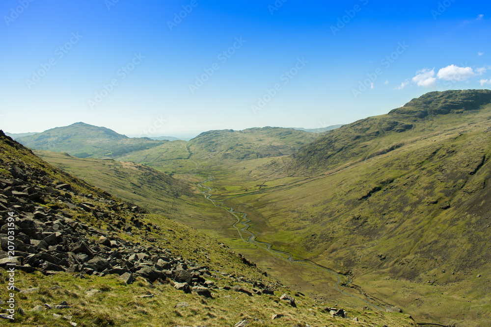 View from Wrynose Pass looking down the valley to Hard Knott and Cockley Beck in the Lake District, UK, taken during the 2018 Fred Whitton cycling challenge.