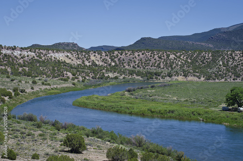 A landscape view of the bending green river through the browns park countryside. 