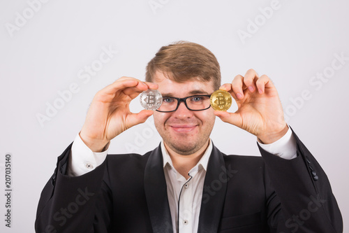 Golden Bitcoin in a man hand, Digital symbol of a virtual cryptocurrency.