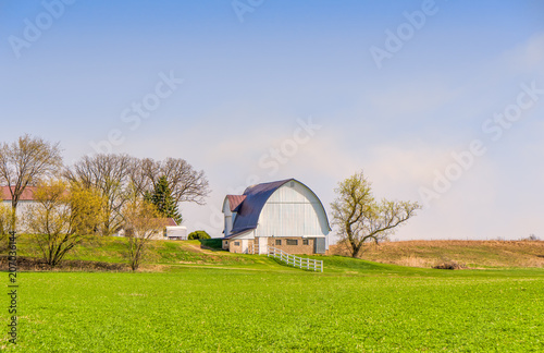 White Barn and Green Field in Spring