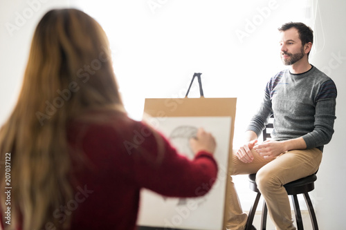 Artist sketching a male model