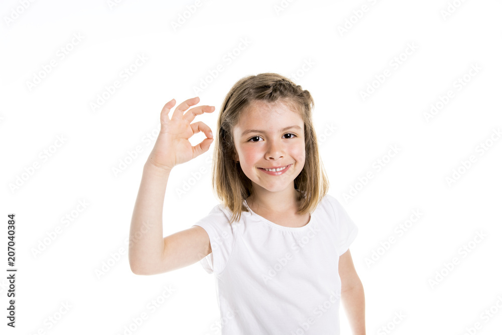 Portrait of a cute 7 years old girl Isolated over white background show positive hand Portrait of a cute 7 years old girl Isolated over white background show positive hand