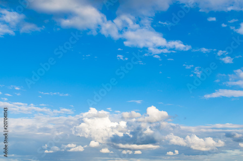 Storm clouds against a bright blue sky.