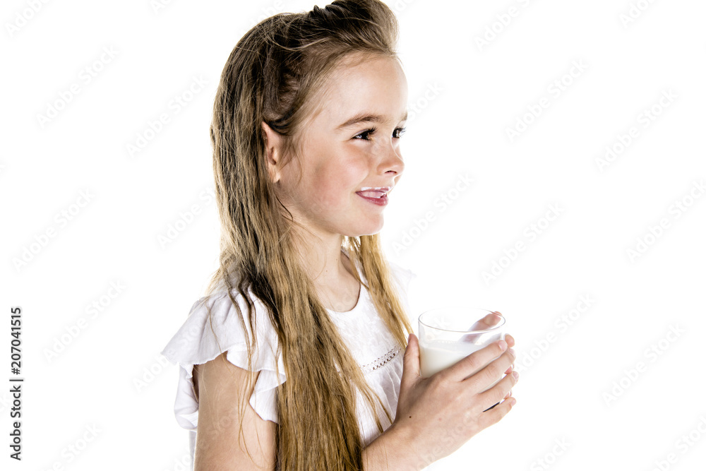 Portrait of a cute 7 years old girl Isolated over white background with milk glass Portrait of a cute 7 years old girl Isolated over white background with milk glass