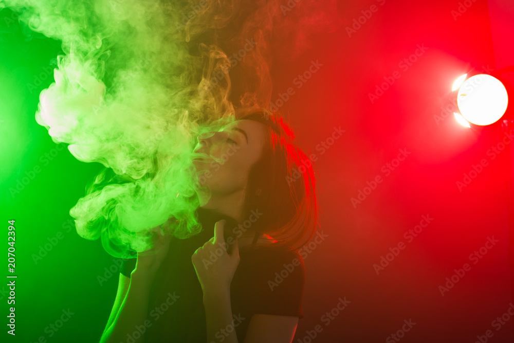 young woman smoking electronic cigarette young woman smoking electronic cigarette
