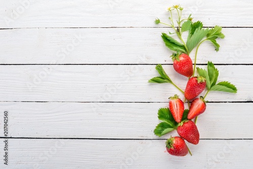 Fototapeta Naklejka Na Ścianę i Meble -  Fresh strawberries. On a white wooden background. Top view. Copy space.