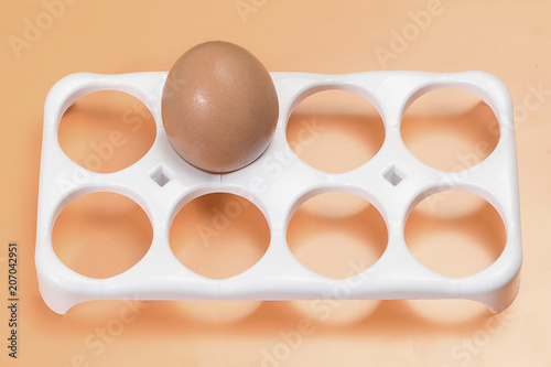 One chicken egg on a stand for a set of eggs photo