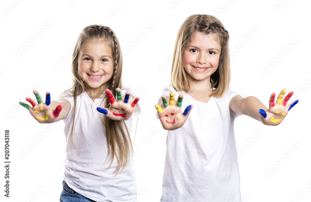 two smiling girls with the palms painted by a paint. Isolated on white background two smiling girls with the palms painted by a paint. Isolated on white background