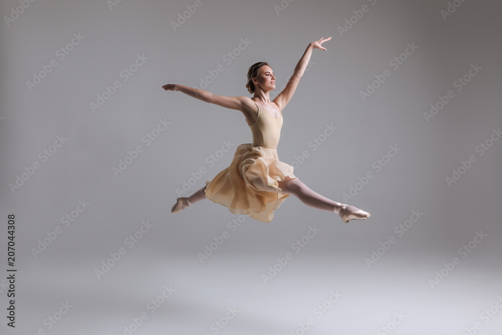 Release your soul! Gorgeous good-looking attractive young tender modern ballet dancer performing art jump with empty copy space background.