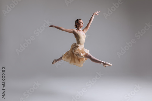 Release your soul  Gorgeous good-looking attractive young tender modern ballet dancer performing art jump with empty copy space background.