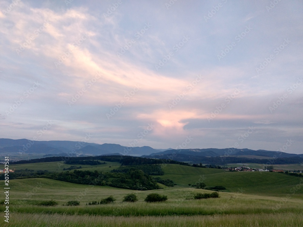 Sunset on meadow with hills and tree. Slovakia	