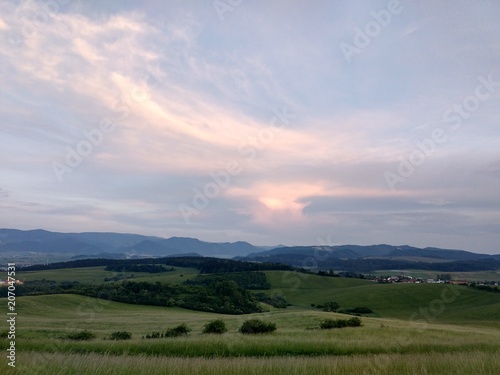 Sunset on meadow with hills and tree. Slovakia 