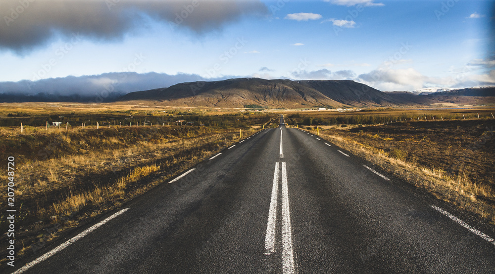 Icelandic lonely road in wild territory with no one in sight Icelandic lonely road in wild territory with no one in sight