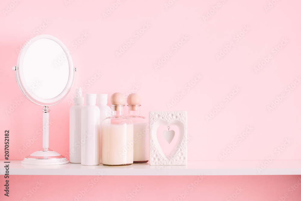 Soft pink light bathroom decor for advertising, design, cover. Cosmetic set on light dressing table,  mirror on a wooden shelf. mock up 