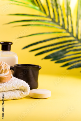 Spa bath setting, sea salt in wooden bamboo bowl, soap, towel, body lotion, Asian skin care