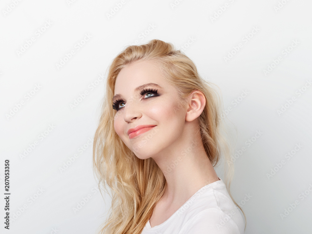 Beauty portrait of model with trendy natural make-up looking up. Fashion shiny highlighter on skin, sexy gloss lips make-up. Beauty portrait of model with trendy natural make-up looking up. Fashion shiny highlighter on skin, sexy gloss lips make-up.
