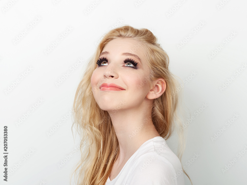 Beauty portrait of model with trendy natural make-up looking up. Fashion shiny highlighter on skin, sexy gloss lips make-up. Beauty portrait of model with trendy natural make-up looking up. Fashion shiny highlighter on skin, sexy gloss lips make-up.