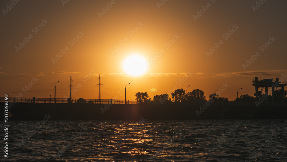 Waves in water reservoir at sunset time in evening, beautiful summer landscape