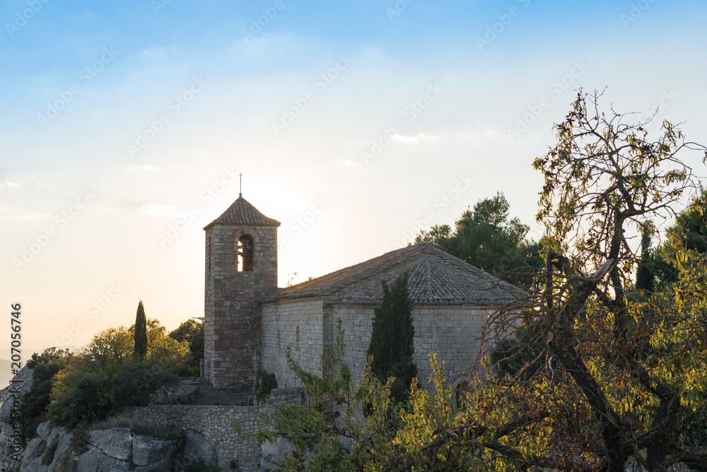 View of the Romanesque church of Santa Maria de Siurana at sunset in Siurana de Prades, Tarragona, Spain. Copy space for text.