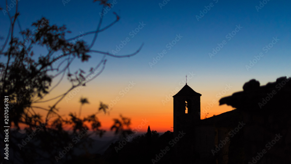 View of the Romanesque church of Santa Maria de Siurana at sunset in Siurana de Prades, Tarragona, Spain. Copy space for text.