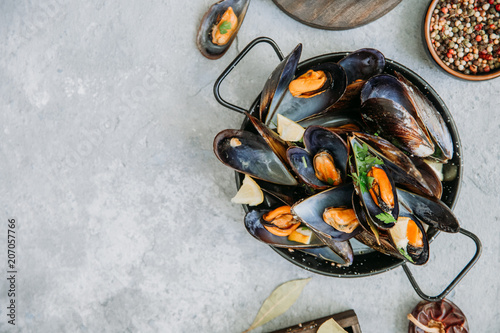  Mussels in wine with parsley and lemon. Seafood concept . Top view, flat lay, copy space photo