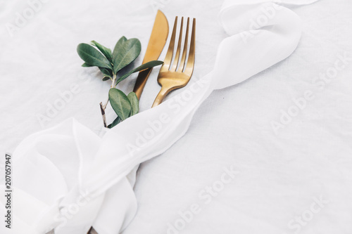Gold table setting in boho style on bright background