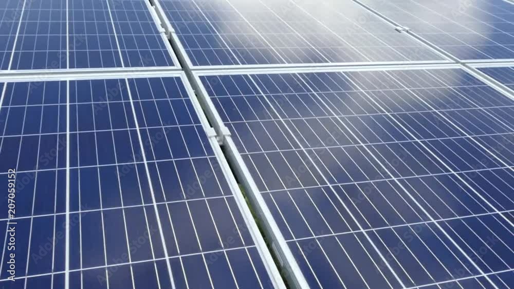 Solar panels on a solar station. The clouds are reflected on the surface of the solar panels. Alternative clean electricity. Polycrystalline and single crystal elements. Solar panels on a solar station. The clouds are reflected on the surface of the solar panels. Alternative clean electricity. Polycrystalline and single crystal elements.