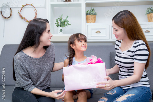 happy of mother and daughter woman asian and aunt with gift with pink ribbon and daughter kissing mother, Happy family concept. Happy mother's day.