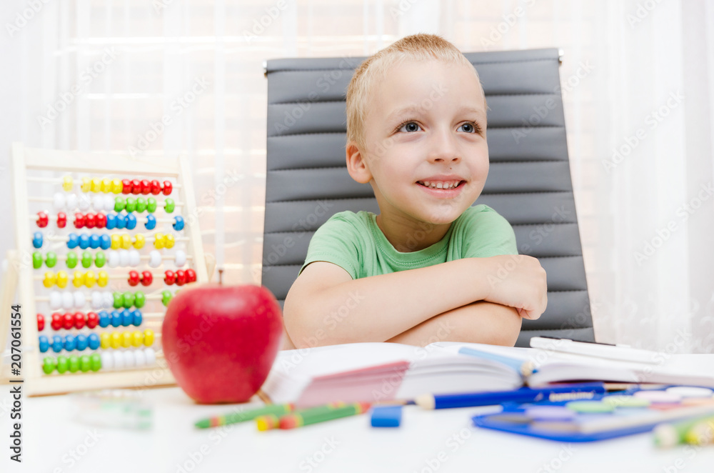 Preschooler, student doing homework at the desk Preschooler, student doing homework at the desk