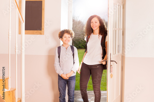 Happy boy and girl coming back home from school