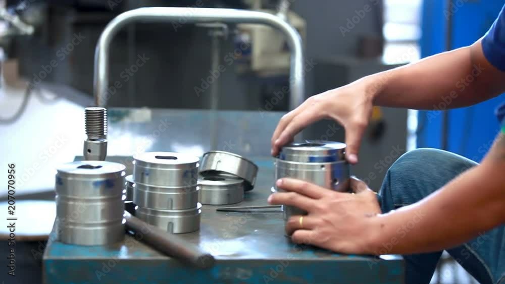 Worker in a factory is inspecting a product in manufactured industrial. Worker in a factory is inspecting a product in manufactured industrial.