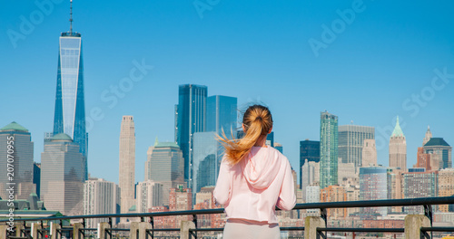 Photography Beautiful woman is walking in sunny day in New York.