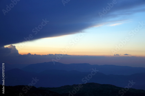 sunset in the clouds on a mountain background