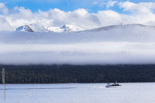 long white cloud and traveling boat in lake te anau most popular traveling destination in southland new zealand photo