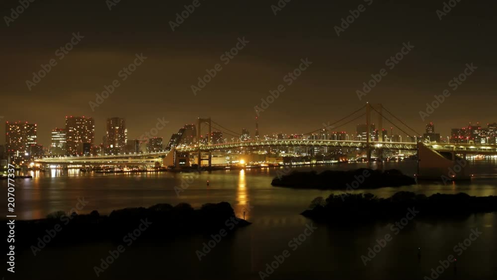 Day to night transition, Tokyo Tower and Rainbow Bridge at night, viewed from Odaiba artificial Island, Tokyo, Honshu, Japan Day to night transition, Tokyo Tower and Rainbow Bridge at night, viewed from Odaiba artificial Island, Tokyo, Honshu, Japan