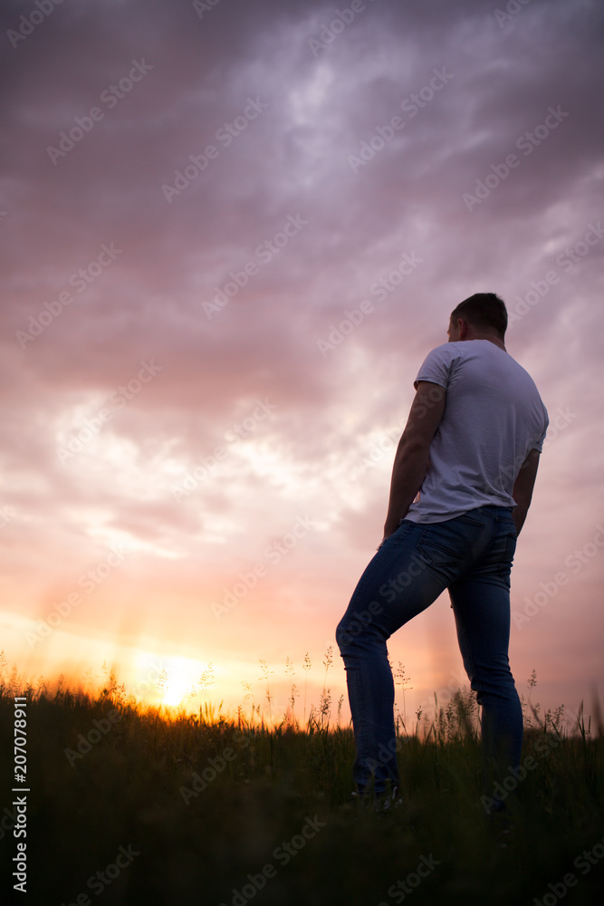 Silhouette of a man against a beautiful sunset sky Silhouette of a man against a beautiful sunset sky