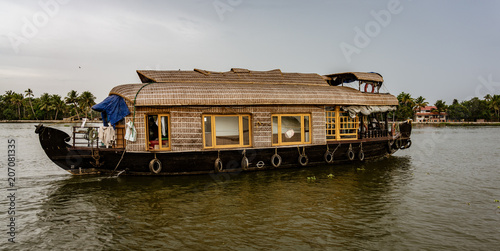 Bamboo thatched houseboat floats down the backwaters of Kerala