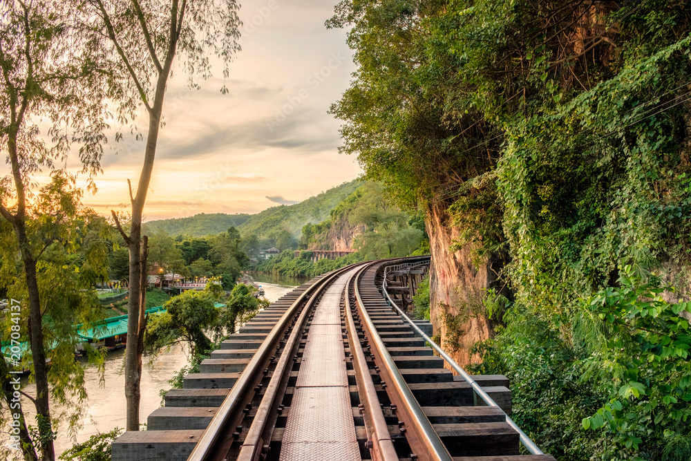 Fototapeta premium Ancient wooden railway historic of world war II at sunset