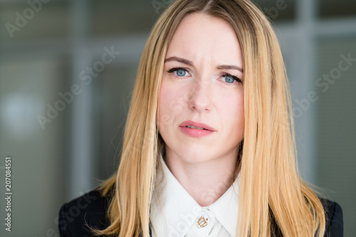 emotion face. woman with a interrogative questioning look. business lady at office workspace. young beautiful blond girl portrait