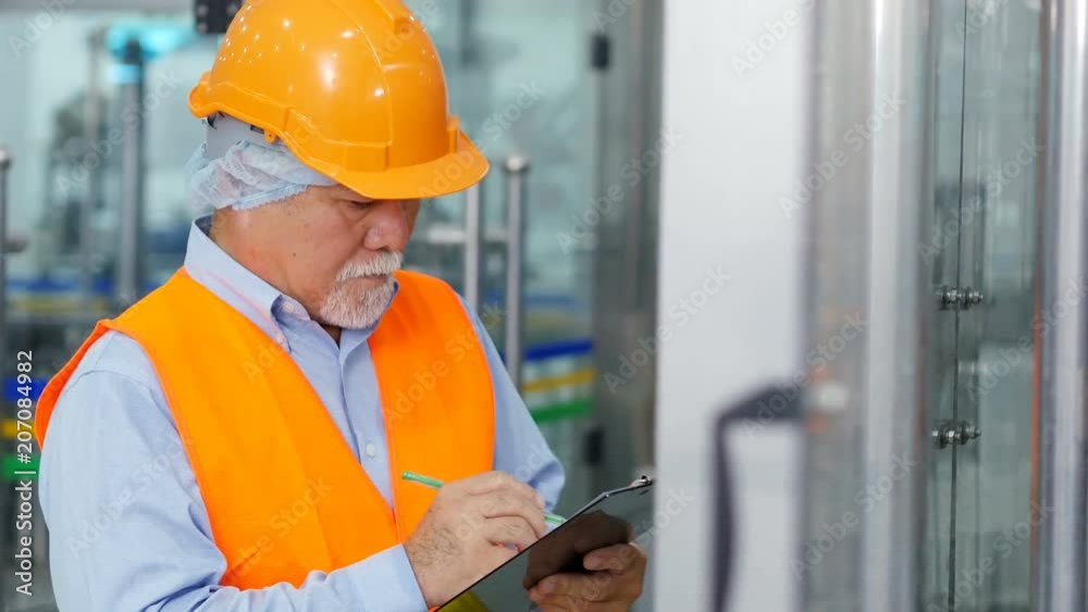 Senior engineer working at production line. Senior engineer working at production line.