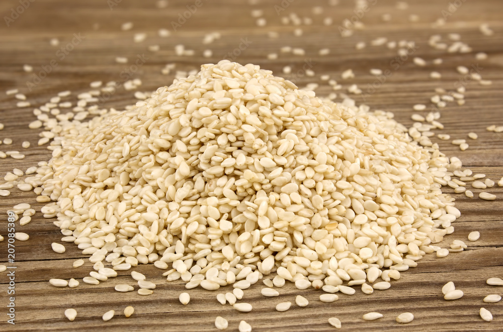 White sesame on wooden background White sesame on wooden background