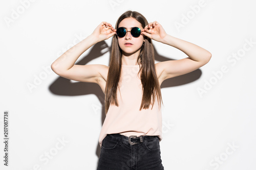 Young teenage woman wearing sunglasses isolated on white