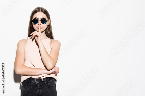 Young fancy woman with finger on lips silence gesture isolated on white background