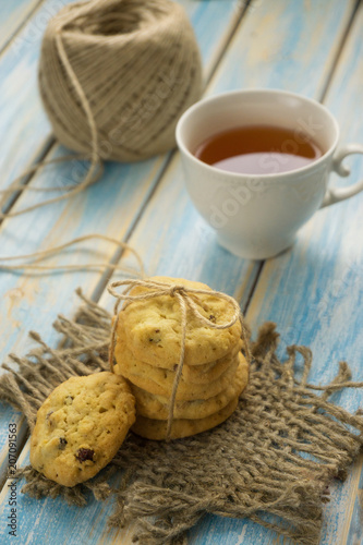 cup of tea with biscuits on a blue wooden background