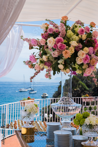 Beautiful flowers and wedding table decorations with with ocean and boats view