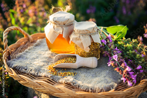 honey and bee pollen on a background of sage flowers