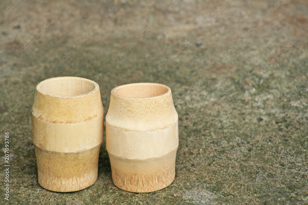 Glass of water made from bamboo wood ,handmade on background Glass of water made from bamboo wood ,handmade on background