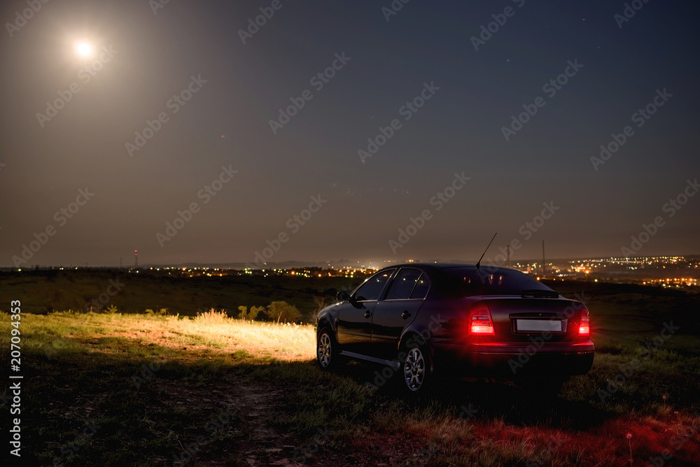 Black car in the field at night Black car in the field at night