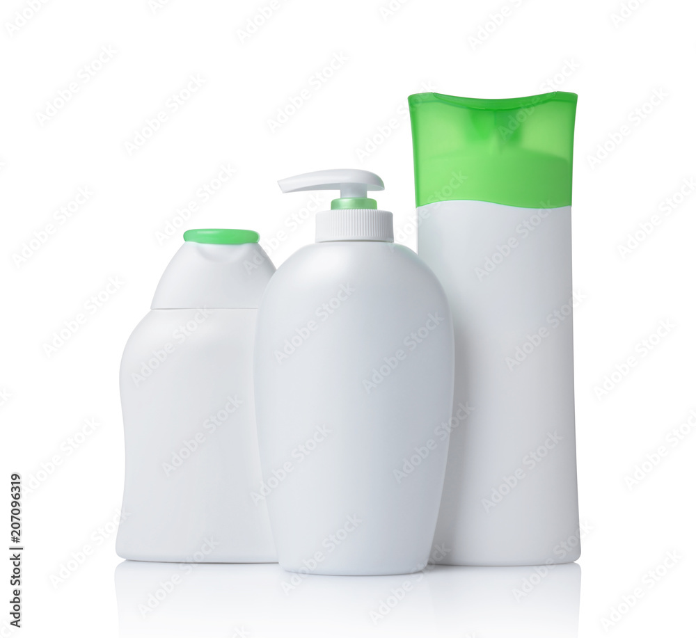 Blank white mockup dispenser and plastic bottles of cosmetic products with green lids Blank white mockup dispenser and plastic bottles of cosmetic products with green lids